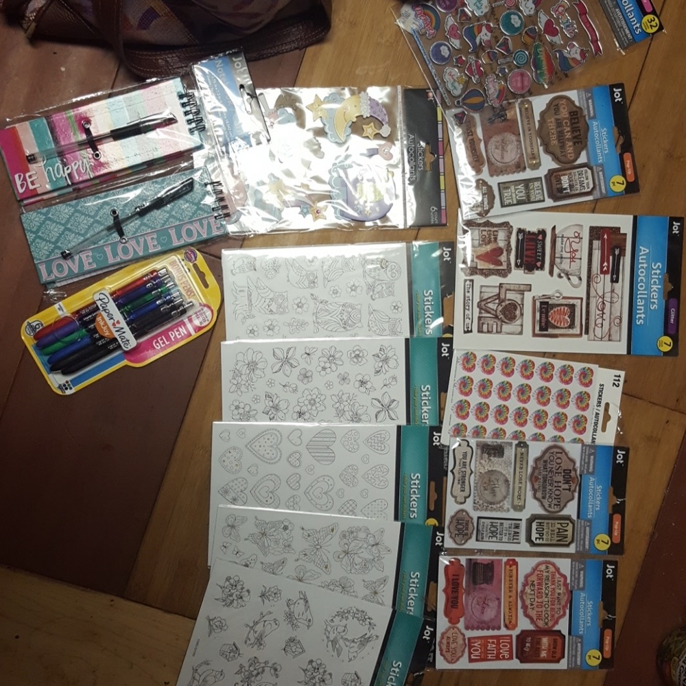 12 packs of stickers & 2 norltepads with pens + ad